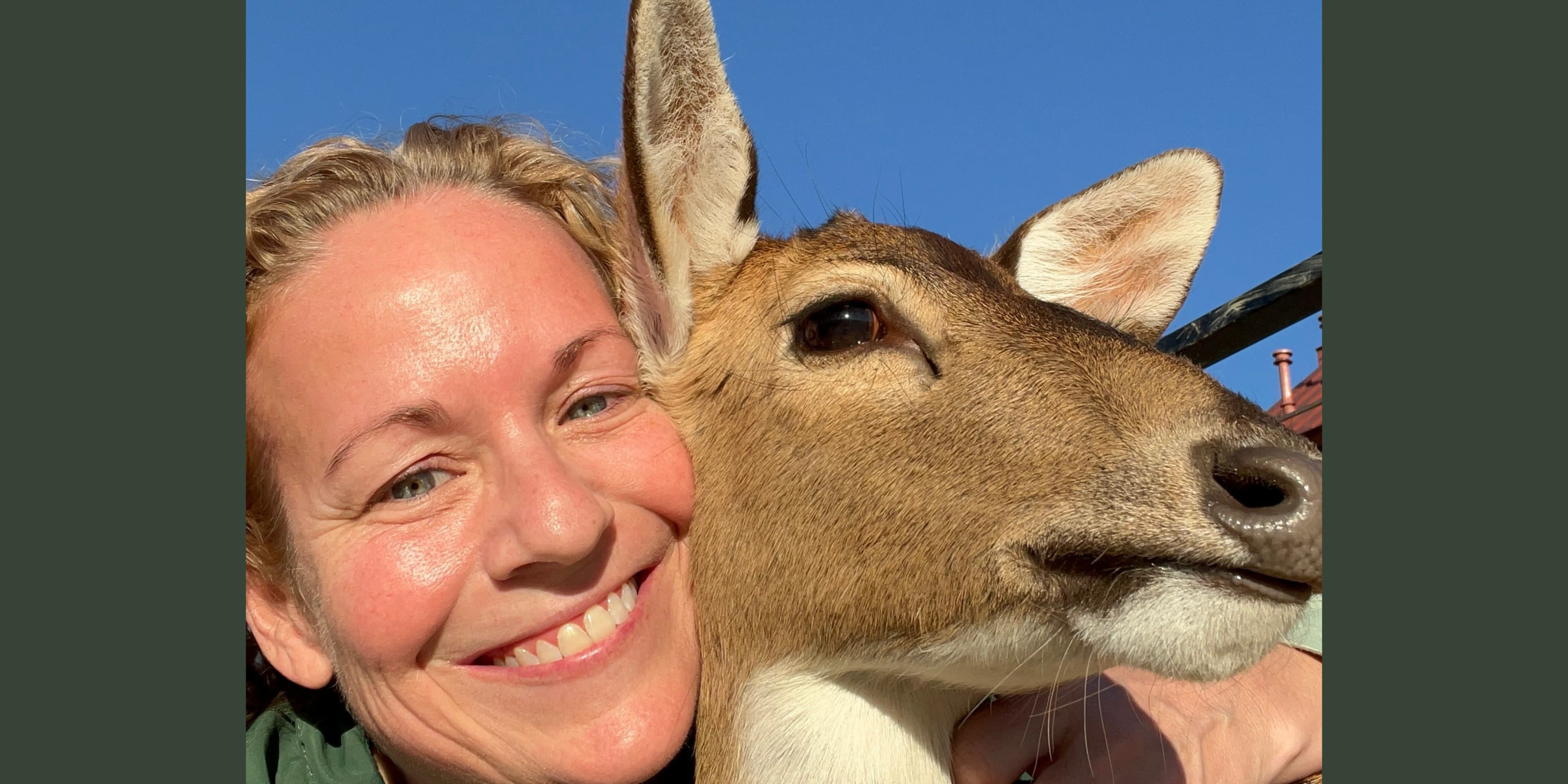 Lisa with Fern the deer beside a bag of NuWild Candy Corn